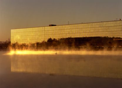 bell labs in holmdel in golden yellow light and reflected in water