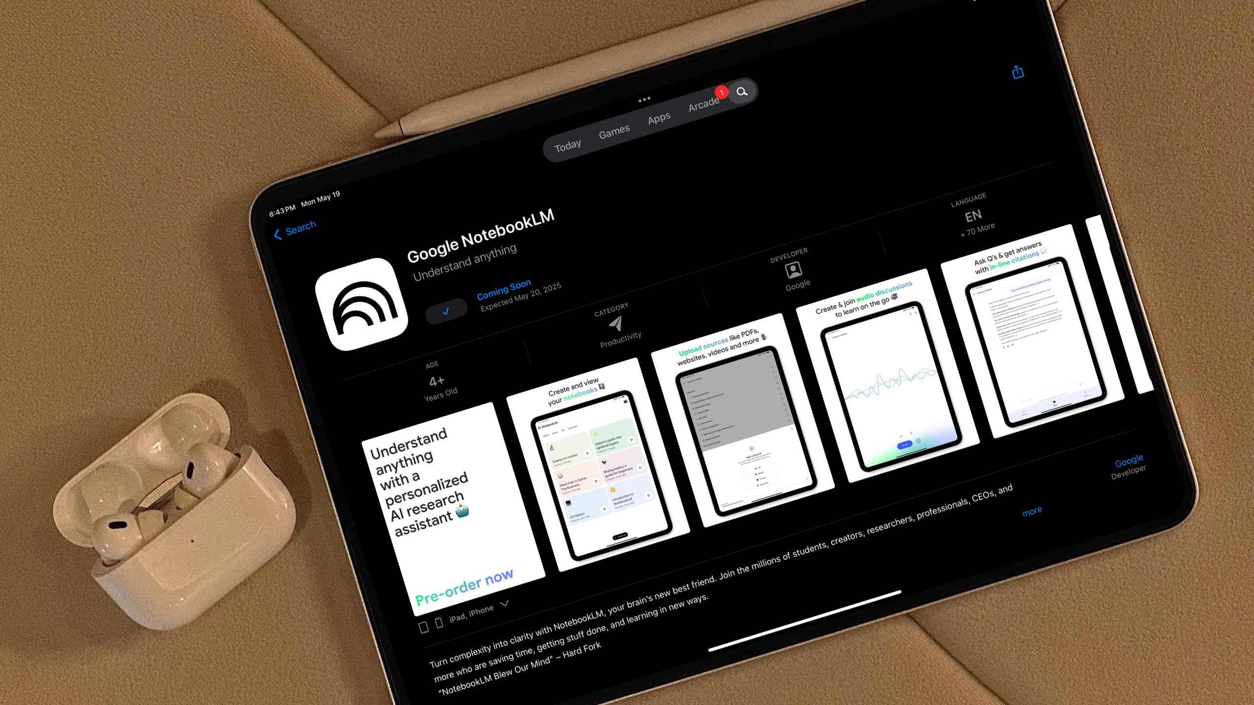iPad and AirPods resting on a sofa, showing the Google NotebookLM app store pre-order page on the iPad screen