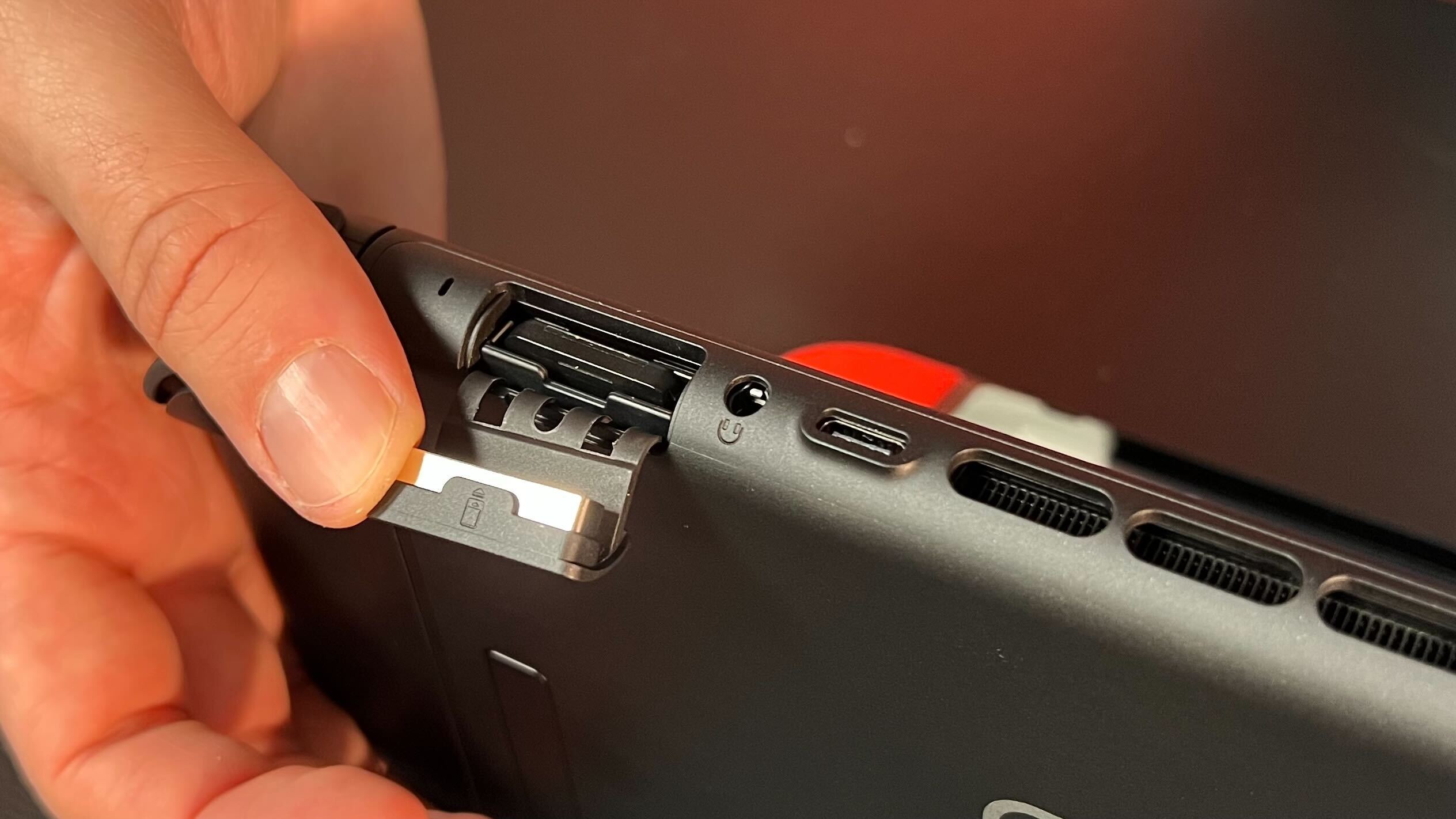 Close up on game card tray of Nintendo Switch 2 with a hand holding it open