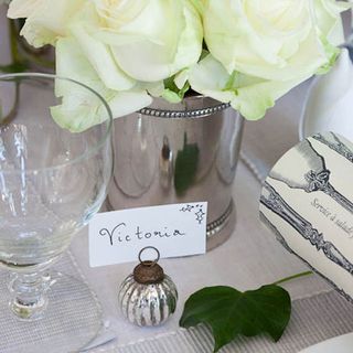 pretty place setting with white tablecloth and flowers