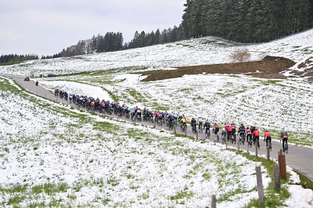 FRIBOURG SWITZERLAND APRIL 24 A general view of the peloton competing in a snowy landscape during the 77th Tour De Romandie 2024 Stage 1 a 1657km stage from Chateau dOex to Fribourg UCIWT on April 24 2024 in Fribourg Switzerland Photo by Luc ClaessenGetty Images