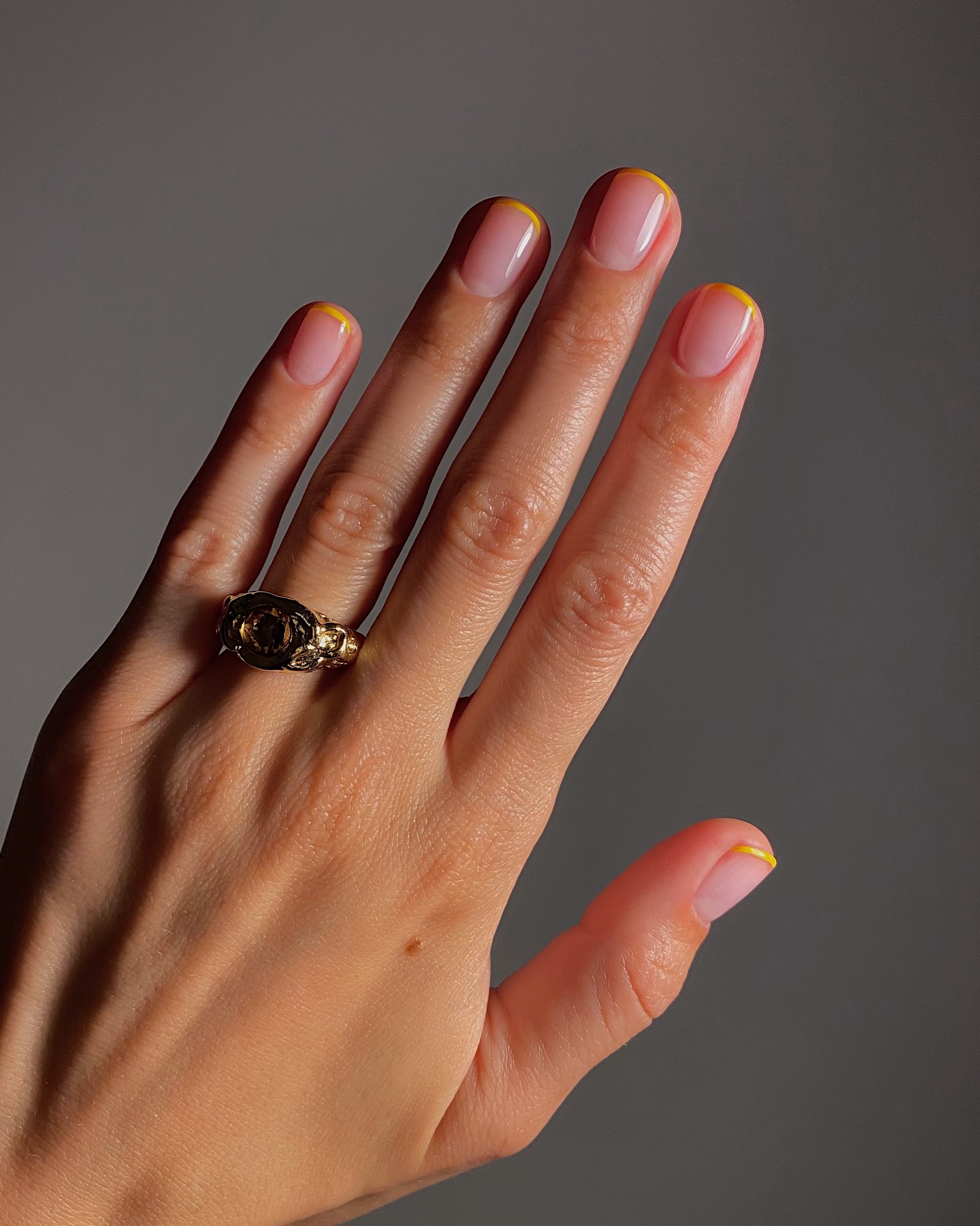 A yellow French tip manicure