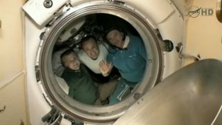 American astronaut Ron Garan (center) and his two Russian crewmates Alexander Samokutyaev (waving) and Andrey Borisenko bid farewell to the International Space Station on Sept. 15, 2011 before undocking from the outpost and returning to Earth.