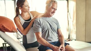 A woman therapist performing sports massage on a man's neck