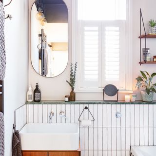 Bathroom with sink on wooden cabinet underneath marble countertop