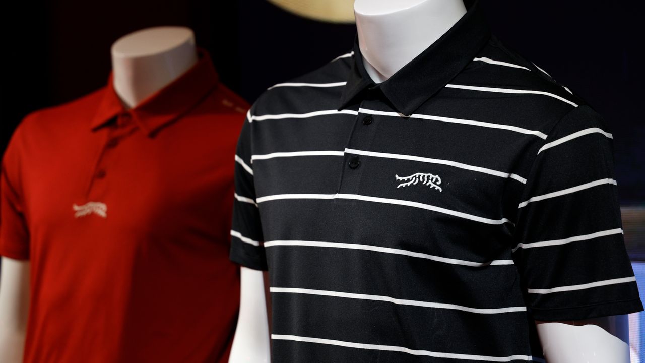 Two polo shirts from Tiger Woods and TaylorMade&#039;s Sun Day Red collection sit on display dummy torsos