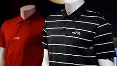 Two polo shirts from Tiger Woods and TaylorMade's Sun Day Red collection sit on display dummy torsos