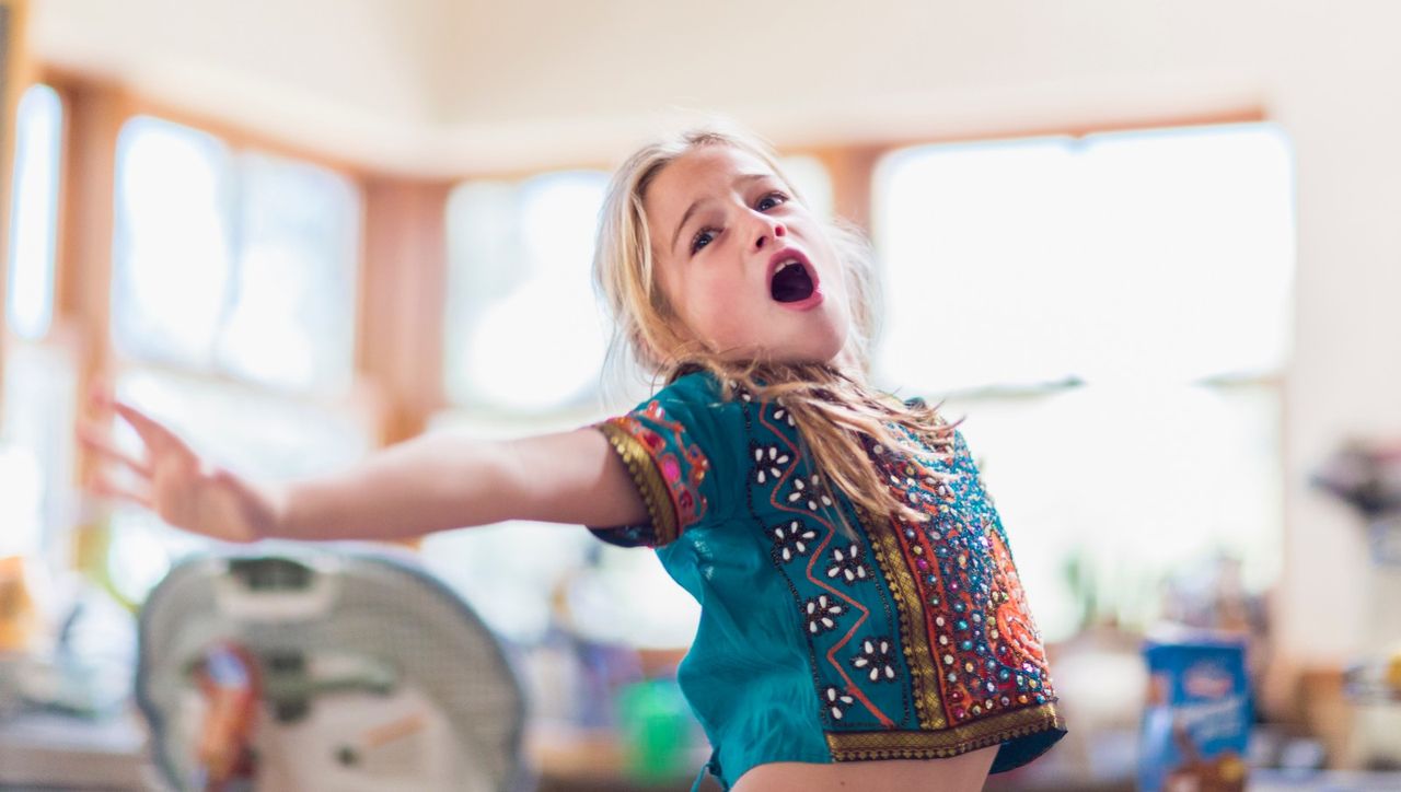 Caucasian girl singing indoors - stock photo