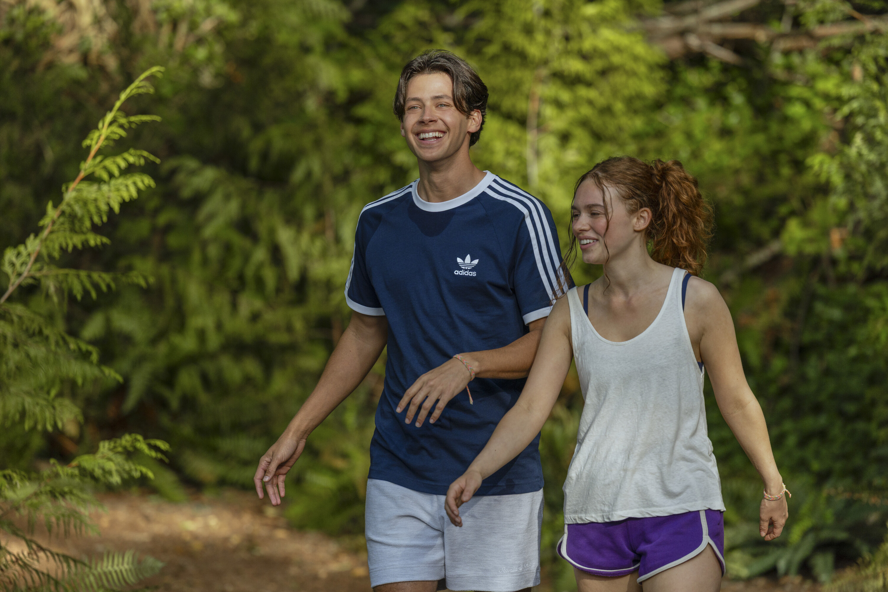 Matt Cornett's Sam and Sadie Soverall's Percy laugh together while on a hike in athletic clothes in a scene from 'Every Year After.'