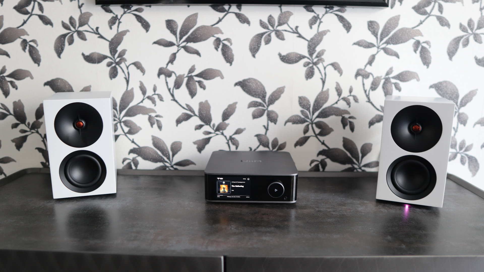 Cambridge Audio's L/R S speakers on a desk. The speakers are white with black tweeters.