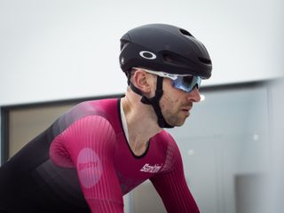 Tom riding in the wind tunnel wearing an aero helmet