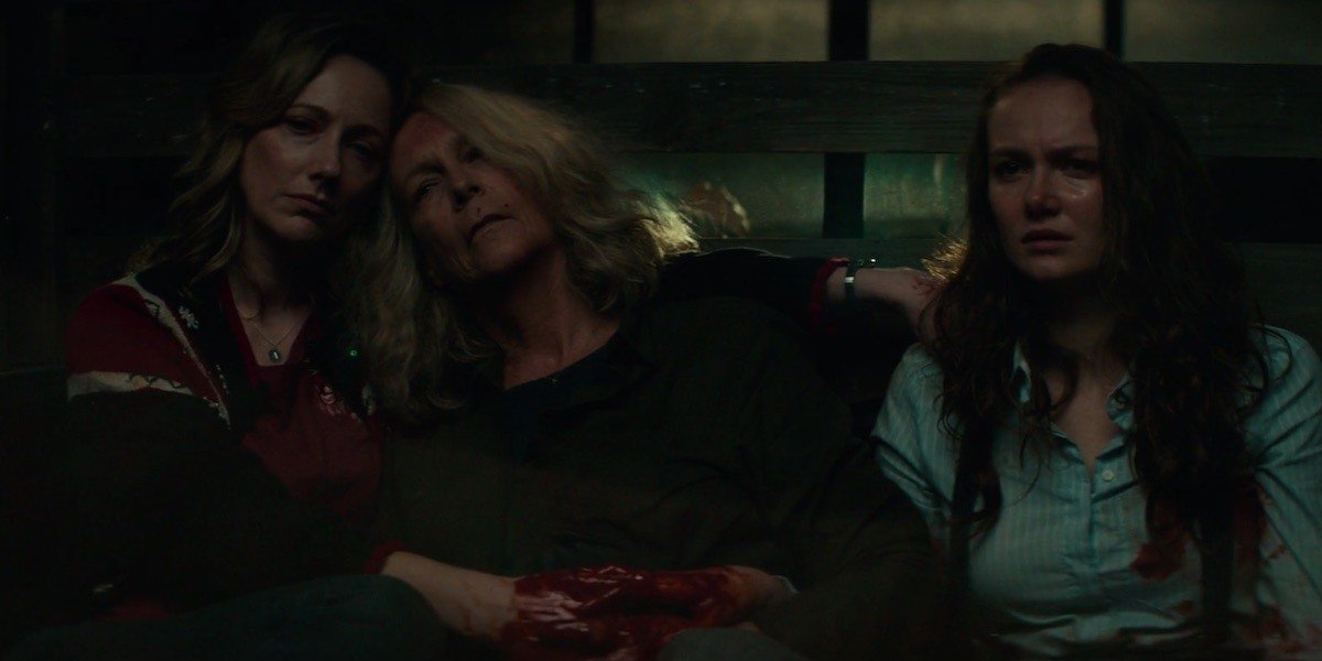 Karen holds a bleeding Laurie while they sit next to Allyson in 2018&#039;s Halloween