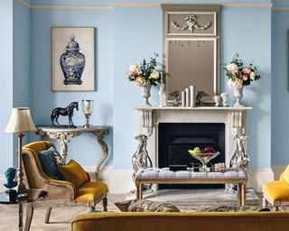 A classic living room with light blue wall paint decor and framed wall art