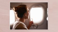 Image of a back view of a woman holding her glasses and looking out of a plane window, set in a white frame against a dusky pink watercolour style background