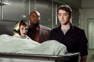 lee pace looks at a dead body in a morgue on the tv show pushing daisies