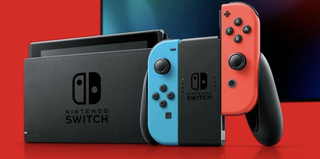 Nintendo Switch half-inside the dock next to connected joy-cons 