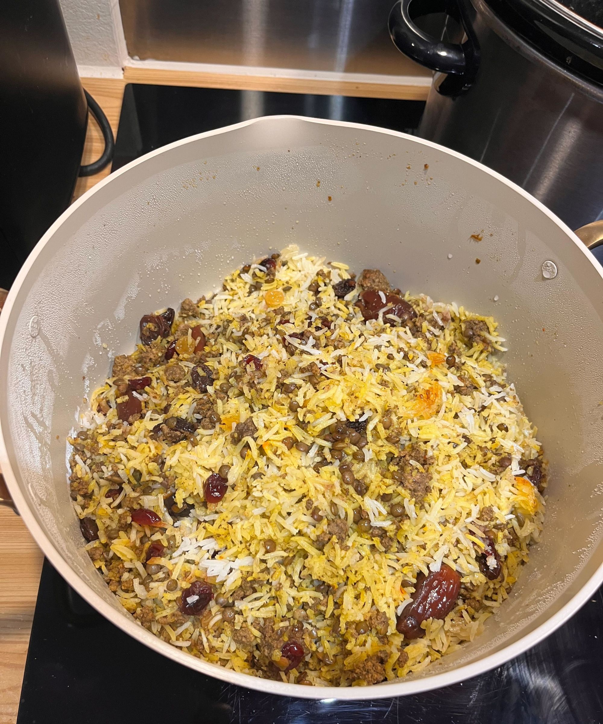 I cooked mixed rice Persian Addas Polo in the set, and it is seen in the stock pot with colorful, fluffy, separated rice mixed with minced beef and dates and sultanas