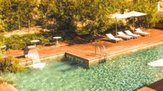 swimming pool and deck chairs at Le Dune Piscinas