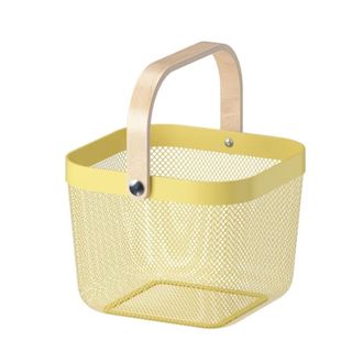 A yellow wire basket with a wooden handle