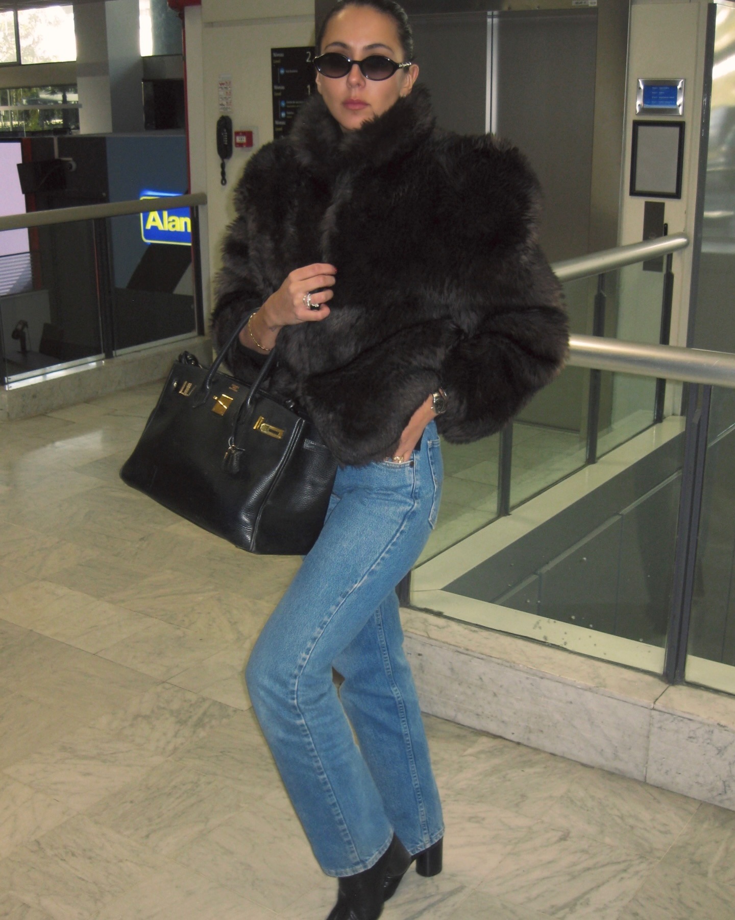 Hanna Marzouki Widlund wearing jeans with a fur jacket and Hermes Birkin bag.