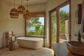 bathtub and open air bathroom in mexican jungle part of four seasons Naviva resort in mexico