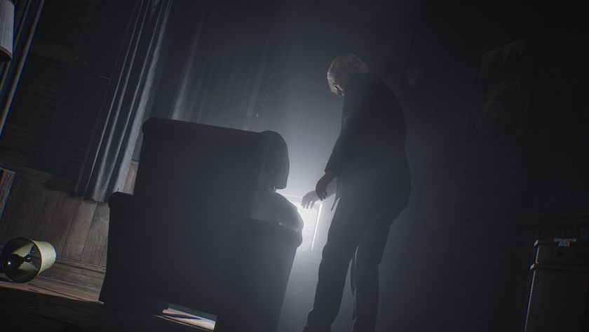 James approaches an armchair in front of a television displaying static