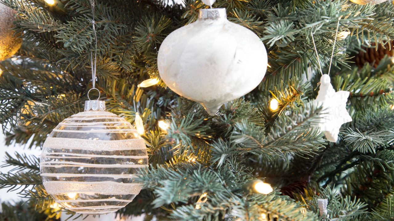 white christmas baubles on christmas tree