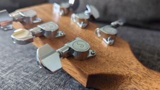 A set of Schaller tuning machines on a Sheeran by Lowden W05 acoustic guitar headstock