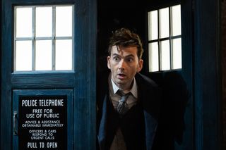 A still from Doctor Who: The Star Beast where the Fourteenth Doctor (David Tennant) pops his head out through the TARDIS doors