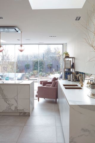 marble kitchen with pink armchairs