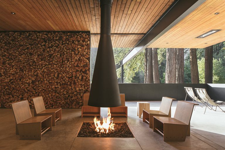 outdoor fireplace with a mid century central flue and low seating