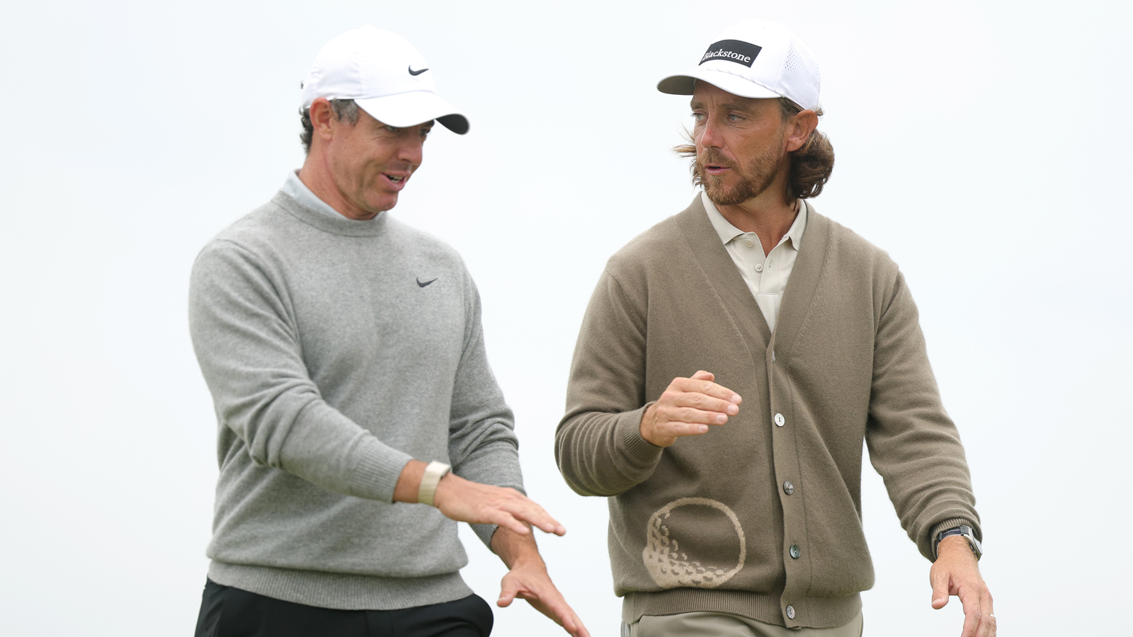 Rory McIlroy and Tommy Fleetwood chat walking down the fairway