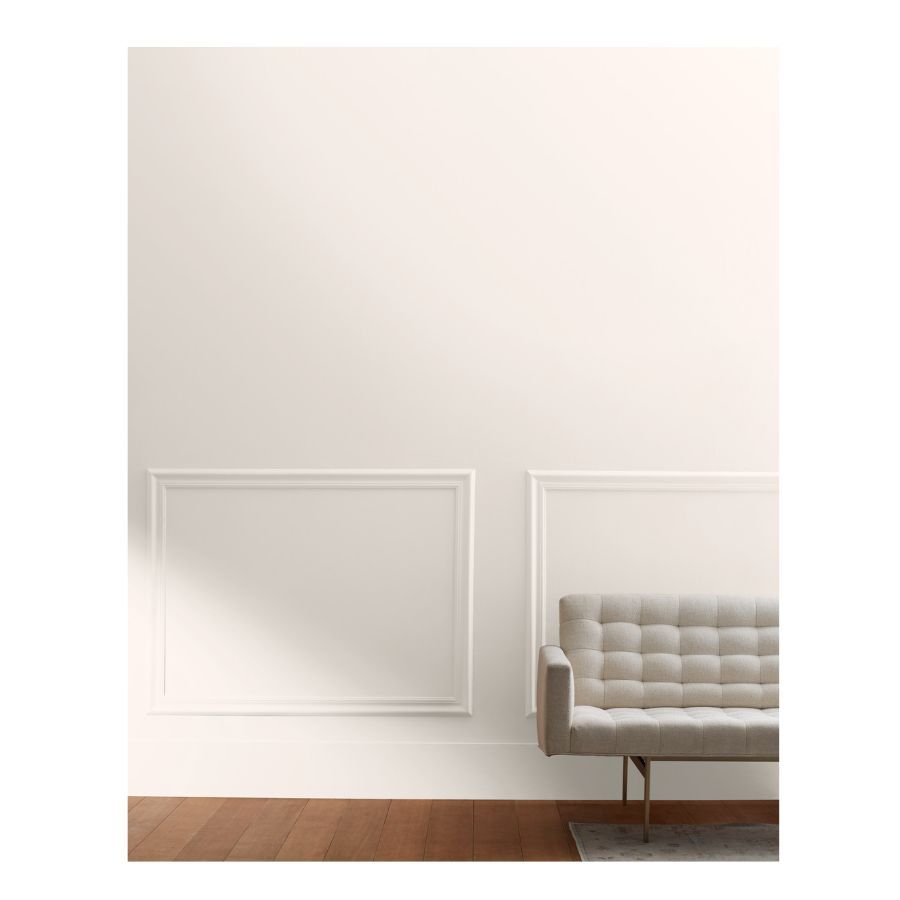 sample of white paint on wall with green bench