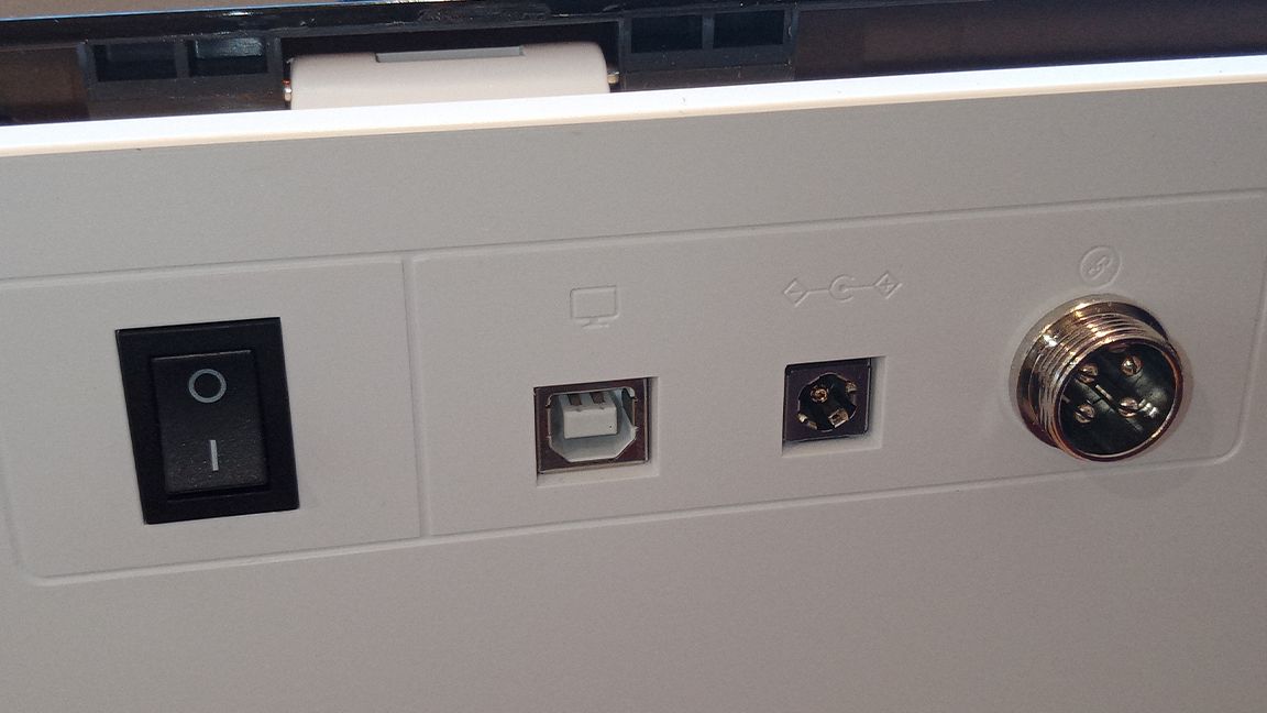 xTool M1 review; a line of ports and connections on the rear of a white box, a laser cutter