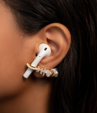 Woman wearing pearl ear cuffs with air pod