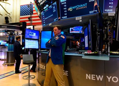 A stock trader reacts to Trump's tariffs on the NYSE