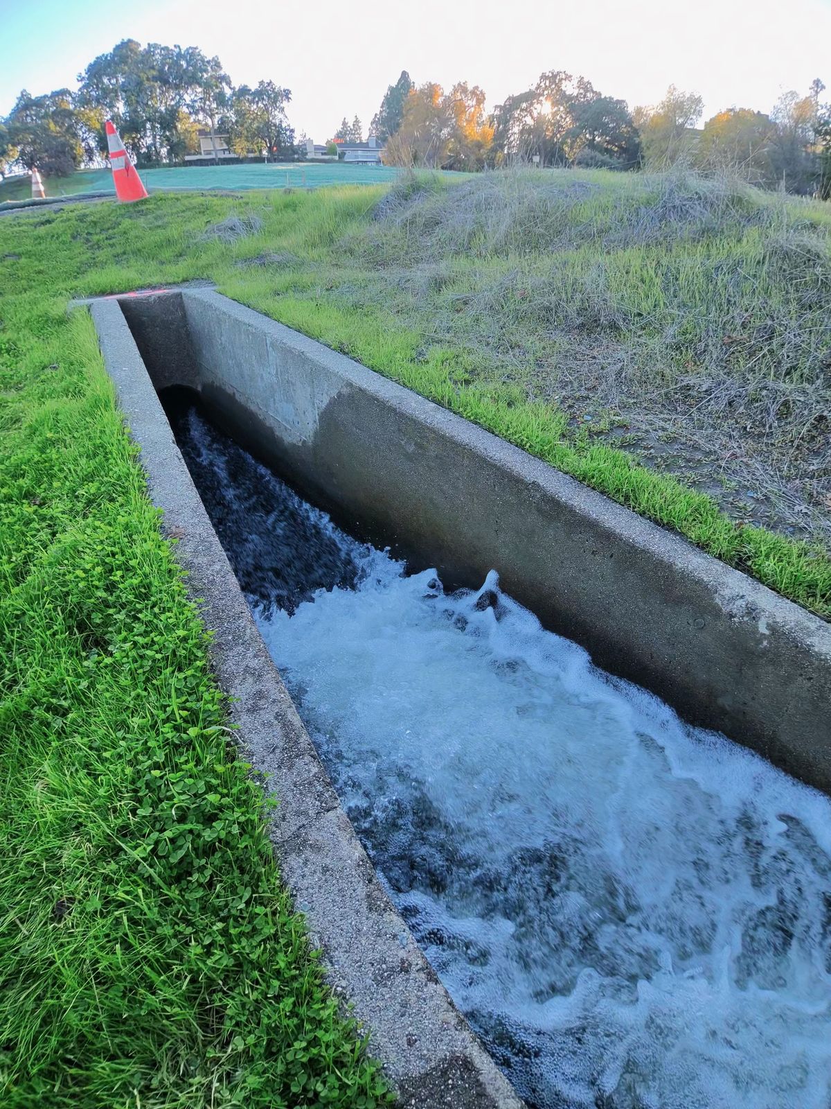 A photo taken with the Oakley Meta Vanguard smart glasses, showing fast-moving water in a small aqueduct.