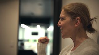 celine dion's side profile as she grimaces and makes a fist, in the documentary 'i am: celine dion'