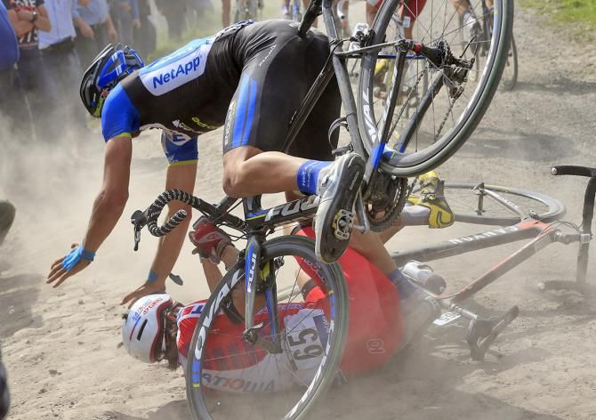 Viacheslav Kuznetsov (Katusha) hits the deck at Paris-Roubaix and is then hit by Blaž Jarc (NetApp-Endura)