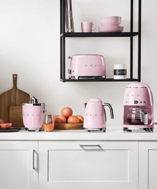 A selection of pastel pink Smeg small kitchen appliances