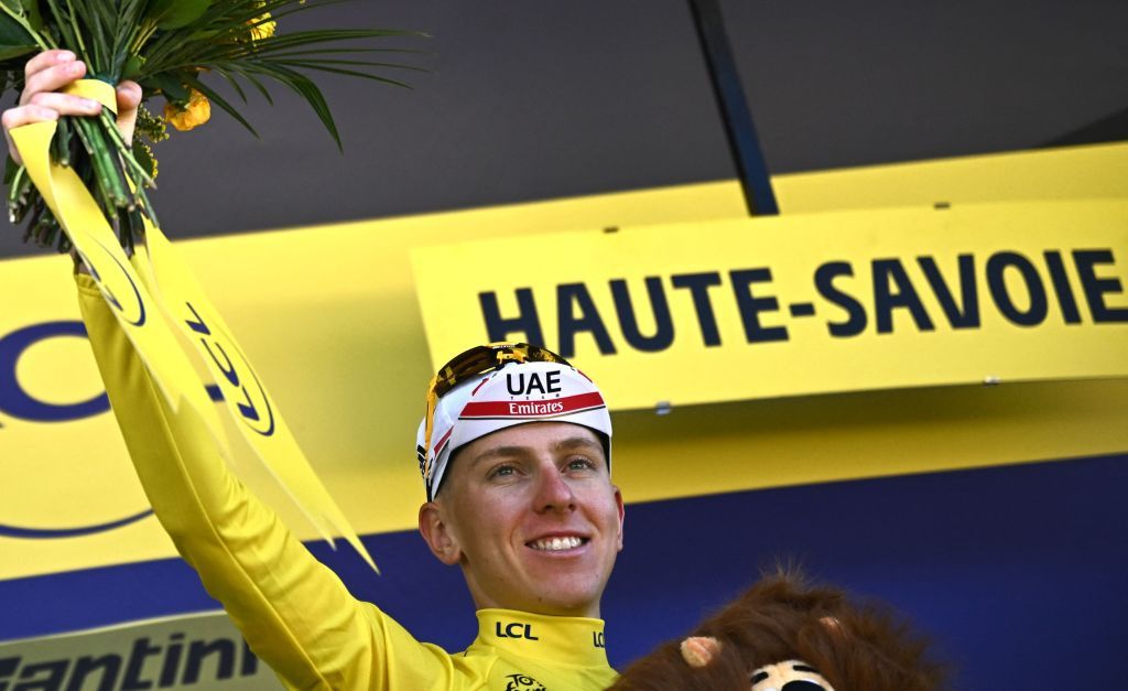UAE Team Emirates teams Slovenian rider Tadej Pogacar R celebrates on the podium with the overall leaders yellow jersey after the 10th stage of the 109th edition of the Tour de France cycling race 1481 km between Morzine and Megeve in the French Alps on July 12 2022 Photo by AnneChristine POUJOULAT AFP Photo by ANNECHRISTINE POUJOULATAFP via Getty Images