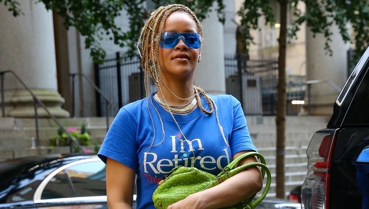 Rihanna wearing an I&#039;m Retired Tshirt dress from british designer Connor Ives with a Bottega Veneta bag while out in new york city