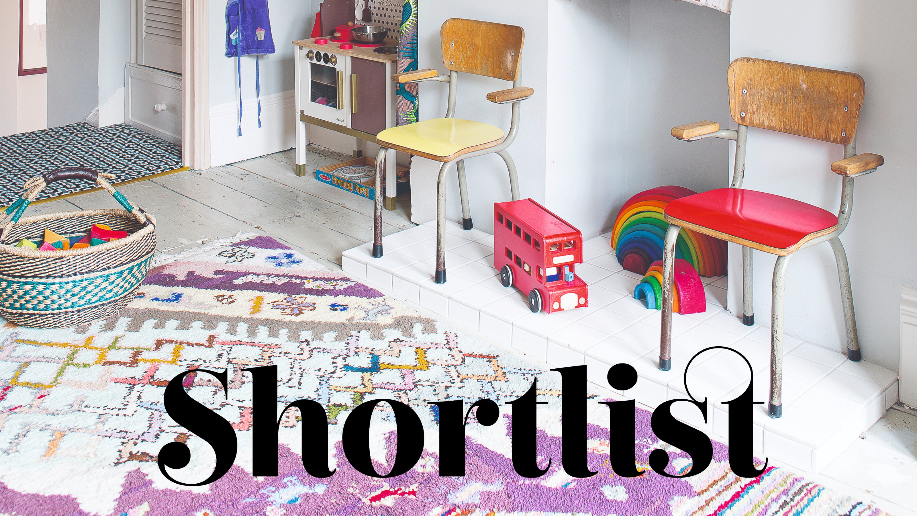 A playroom with a patterned colourful Berber-style rug and rattan baskets filled with toys