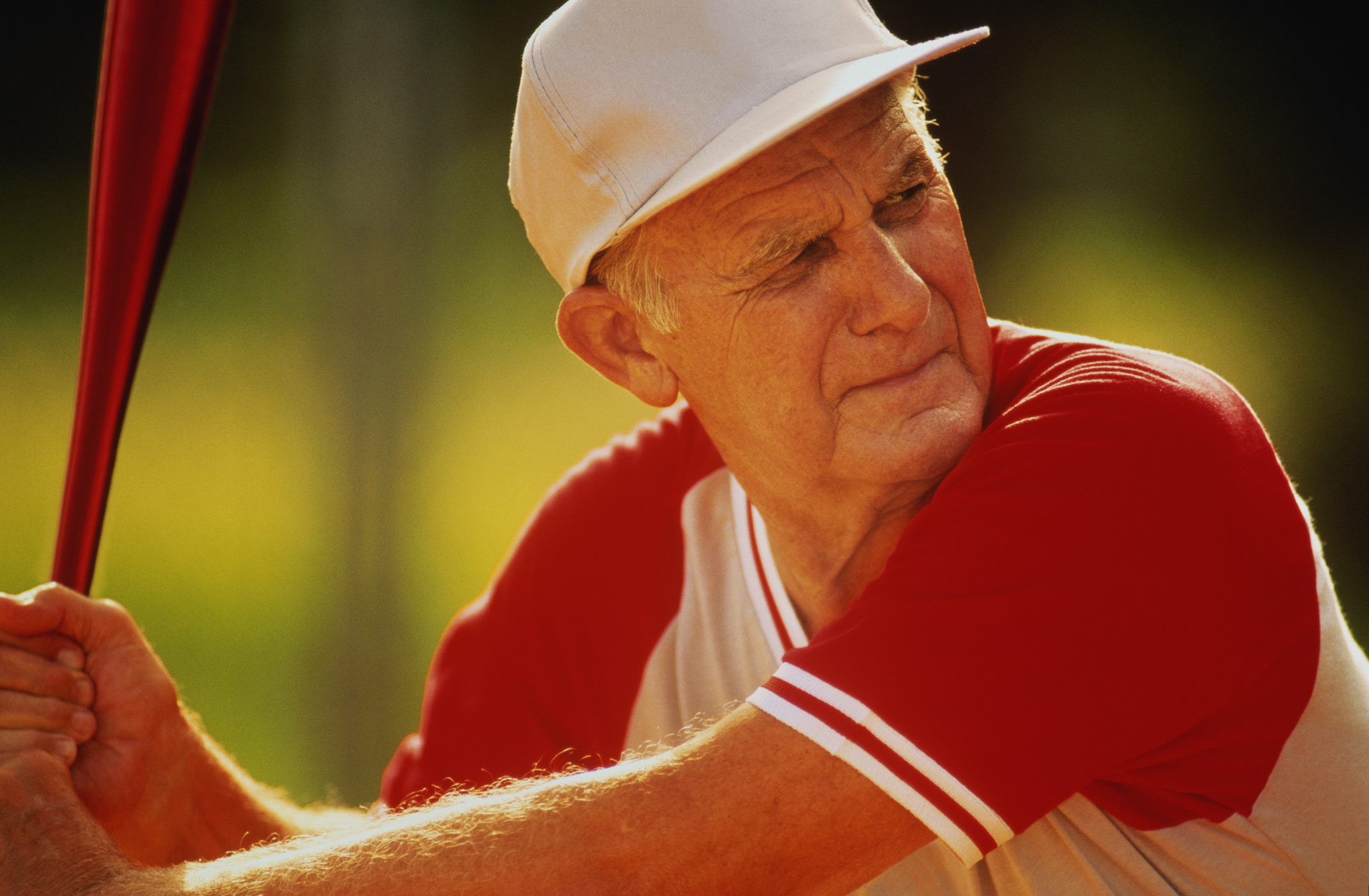 Older man at bat in a softball game.