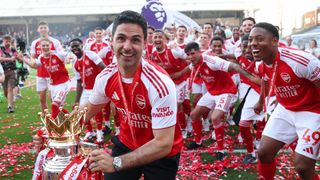 Mikel Arteta and the Arsenal team celebrate winning the Premier League