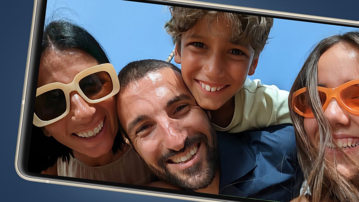 A Google Pixel phone showing a group photo of a family smiling