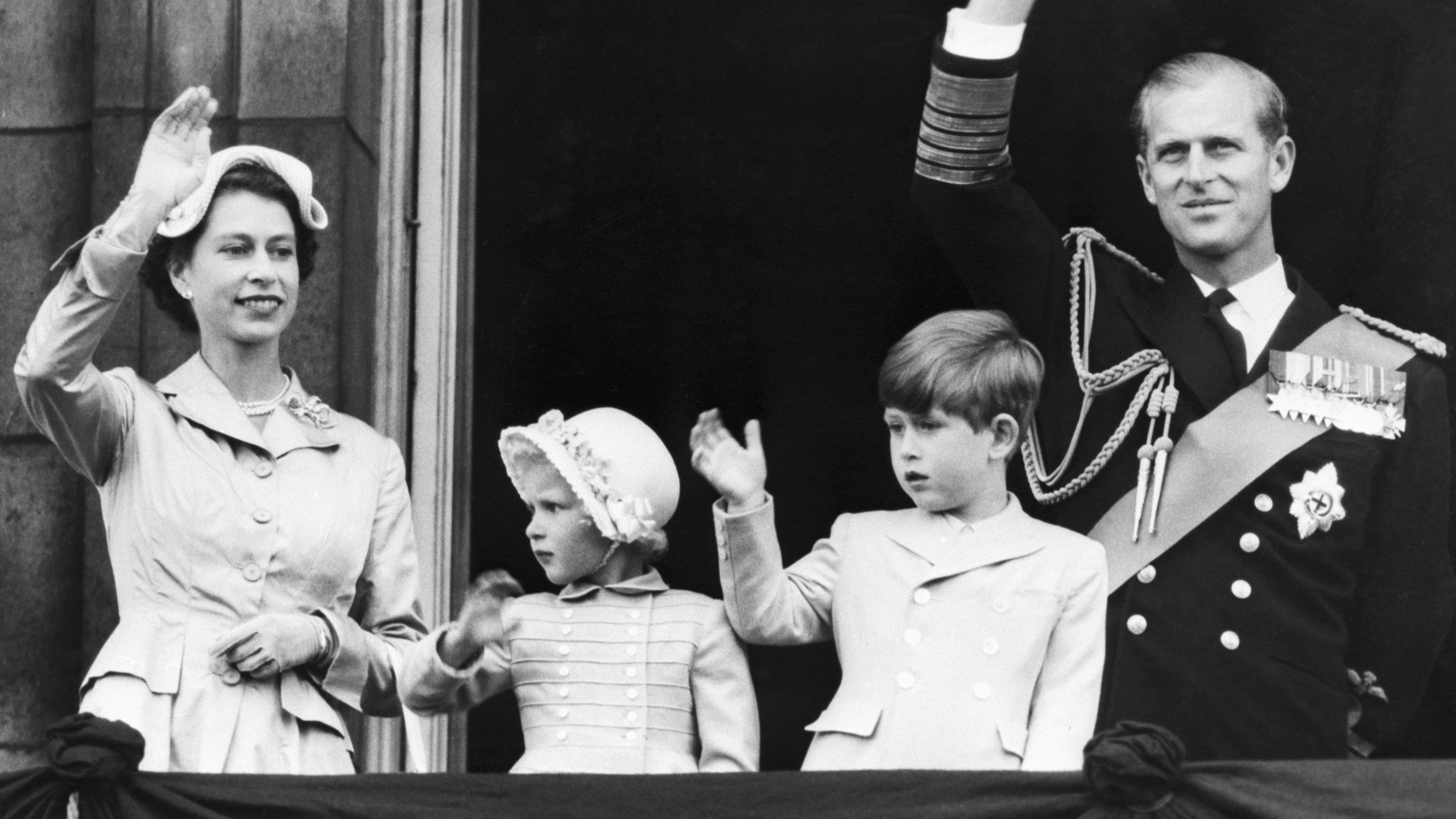 Queen Elizabeth II, Princess Anne, King Charles and Prince Philip wave on the balcony of Buckingham Palace on May 15, 1954
