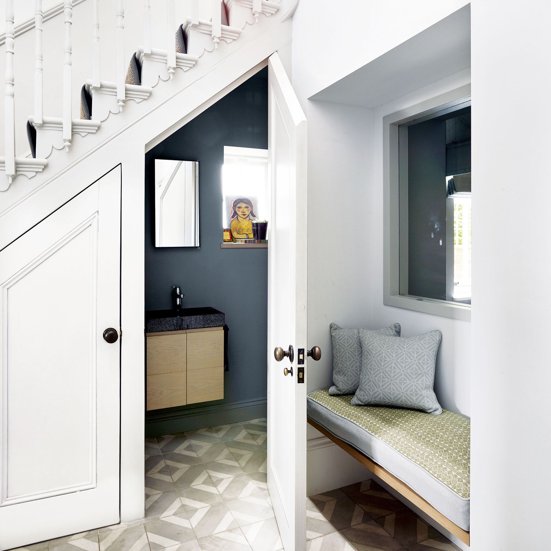 hallway area with downstairs toilet, bench seating and staircase