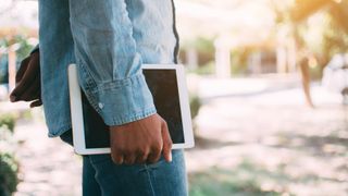 Man carrying tablet under arm