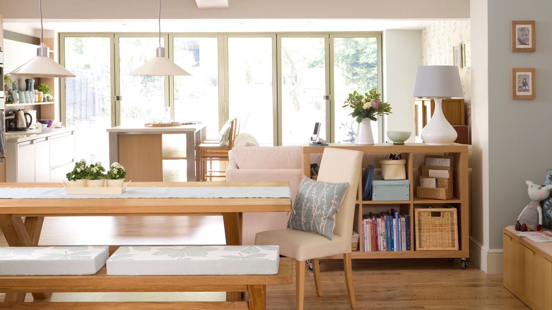 open plan kitchen with wooden dining table with bench seating